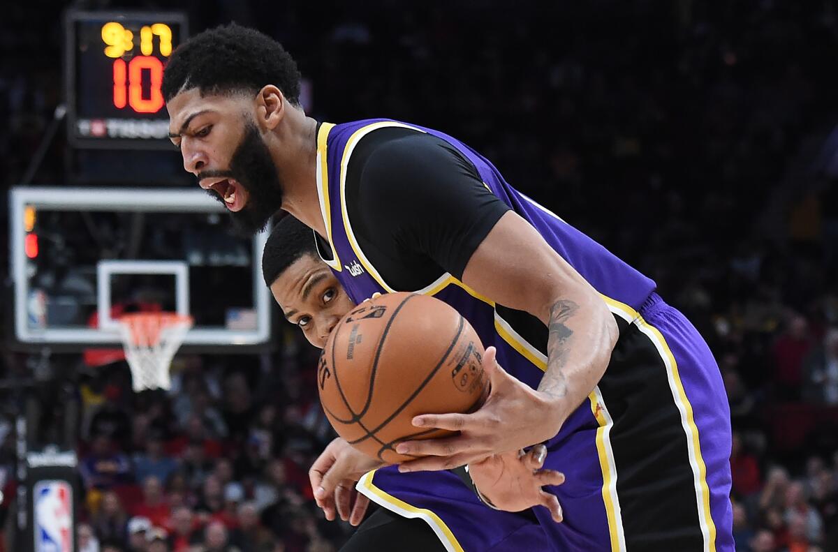 PORTLAND, OREGON - DECEMBER 06: Kent Bazemore #24 of the Portland Trail Blazers reaches in on Anthony Davis #3 of the Los Angeles Lakers during the second half of the game at Moda Center on December 06, 2019 in Portland, Oregon. The Lakers won 136-113. NOTE TO USER: User expressly acknowledges and agrees that, by downloading and or using this photograph, User is consenting to the terms and conditions of the Getty Images License Agreement. (Photo by Steve Dykes/Getty Images) ** OUTS - ELSENT, FPG, CM - OUTS * NM, PH, VA if sourced by CT, LA or MoD **