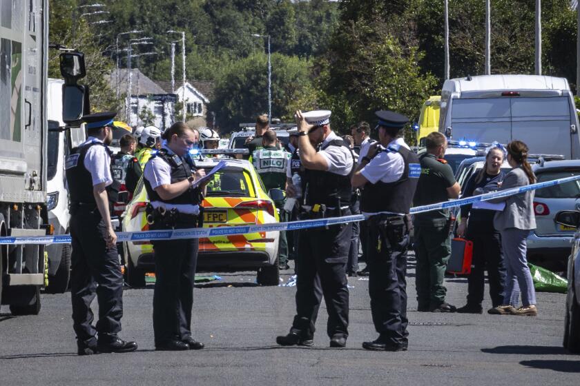 Police secure the area, where a man has been detained and a knife has been seized after a number of people were injured in a reported stabbing, in Southport, Merseyside, England, Monday July 29, 2024. (James Speakman/PA via AP)