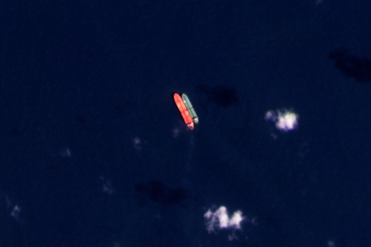 In this satellite photo provided by Planet Labs PBC, vessels identified as the Virgo, left, and the Suez Rajan by the advocacy group United Against Nuclear Iran are seen in the South China Sea on Saturday, Feb. 13, 2022. The Suez Rajan a tanker owned by Fleetscape, a subsidiary of Los Angeles-based Oaktree Capital Management, likely took part in the illicit trade of Iranian crude oil at sea despite American sanctions targeting the Islamic Republic amid the collapse of its nuclear deal with world powers, the advocacy group alleges. The firm said Thursday, Feb. 17, 2022, that it is cooperating with U.S. government investigators. (Planet Labs PBC via AP)