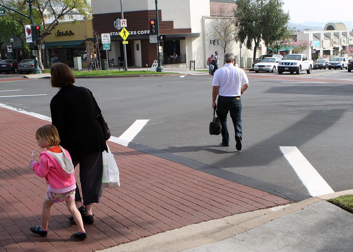 Pedestrians use the diagonal crosswalk at the intersection of Ocean View Blvd. and Honolulu Avenue on Friday, February 20, 2015.