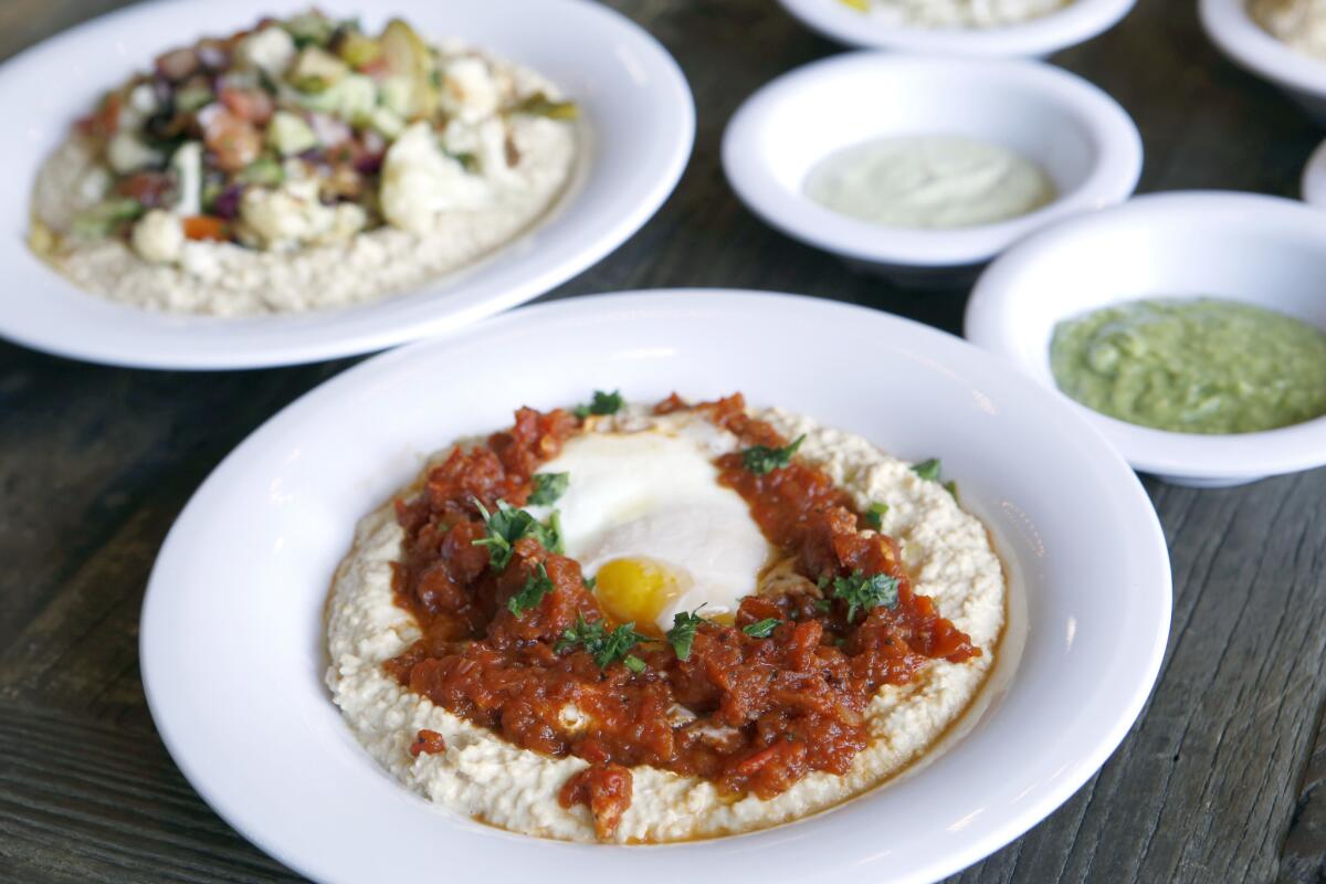 The Hamshuka Bowl, center, and the Market Bowl, are available at the Hummus Bowl restaurant at the Union Market in Mission Viejo.