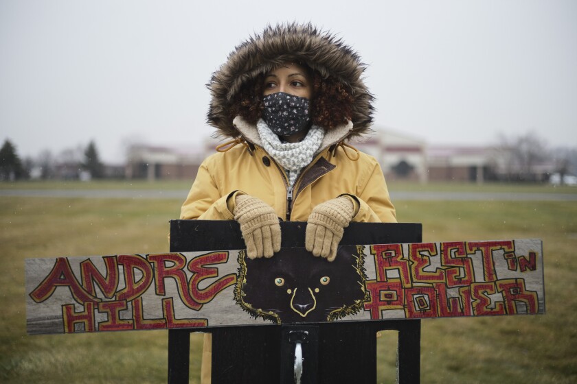 A demonstrator stands outside of First Church of God before the funeral of Andre Hill on Tuesday, Jan. 5, 2021 in Columbus, Ohio. Hill, a 47-year-old Black man, was shot and killed by Columbus Division of Police Officer Adam Coy in the early morning of Dec. 22, 2020 after officers responded to a non-emergency call in the area. (Joshua A. Bickel/The Columbus Dispatch via AP)