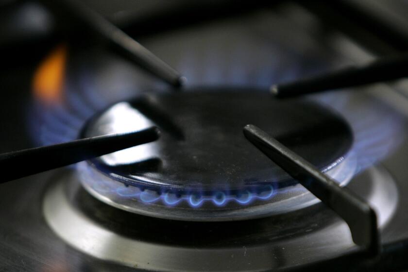 FILE - In this Jan. 11, 2006 file photo, a gas-lit flame burns on a natural gas stove in Stuttgart, Germany. A California restaurant organization is suing Berkeley over the city's ban on natural gas, which is set to take effect in January, 2020. The California Restaurant Association said in its lawsuit filed Thursday, Nov. 21, 2019, that many chefs use natural gas stoves and the prohibition will crimp the San Francisco Bay Area's reputation for international and fine cuisine. (AP Photo/Thomas Kienzle, File)