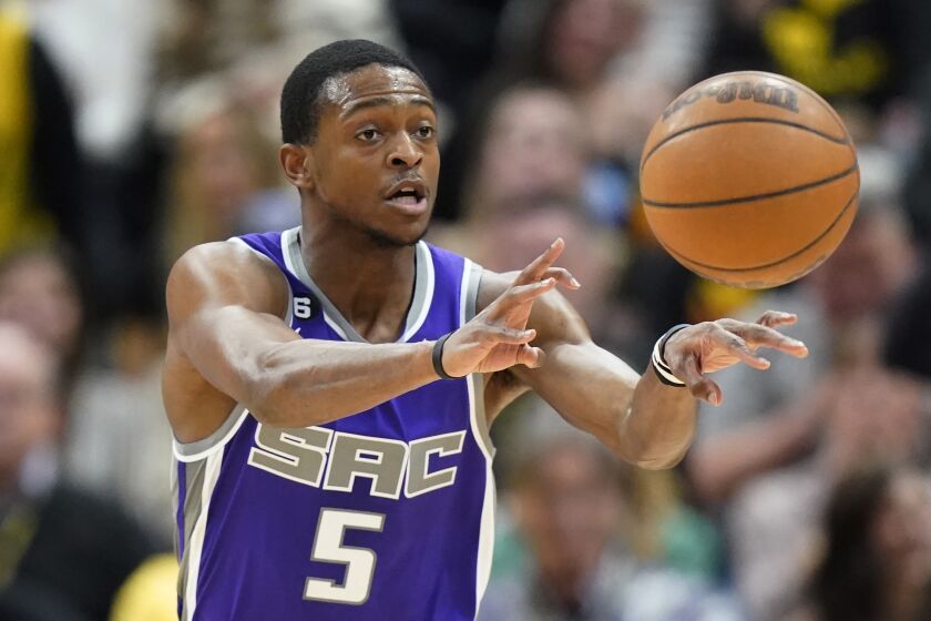 Sacramento Kings guard De'Aaron Fox (5) passes the ball in the first half during an NBA basketball game against the Utah Jazz, Monday, March 20, 2023, in Salt Lake City. (AP Photo/Rick Bowmer)