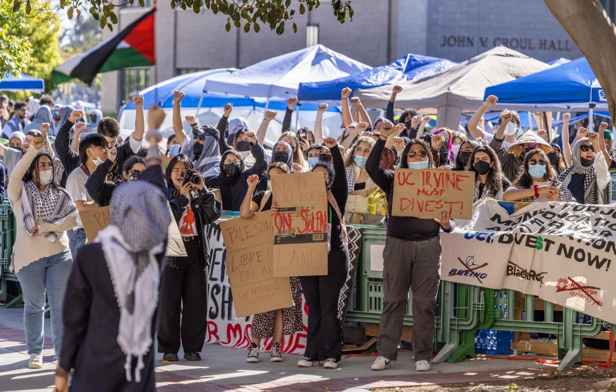 Pro-palestinian protesters demonstrate next to their encampment in the central part of the UC Irvine campus.