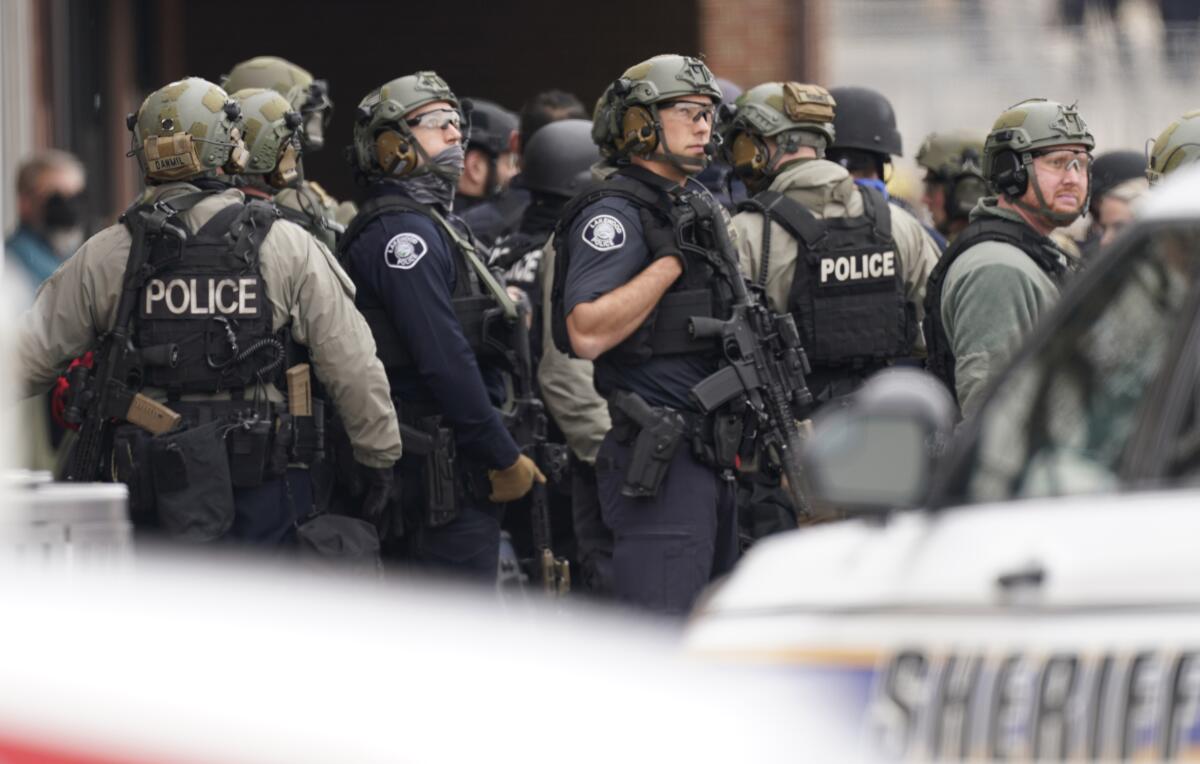 Police in protective gear stand outside a King Soopers grocery store.