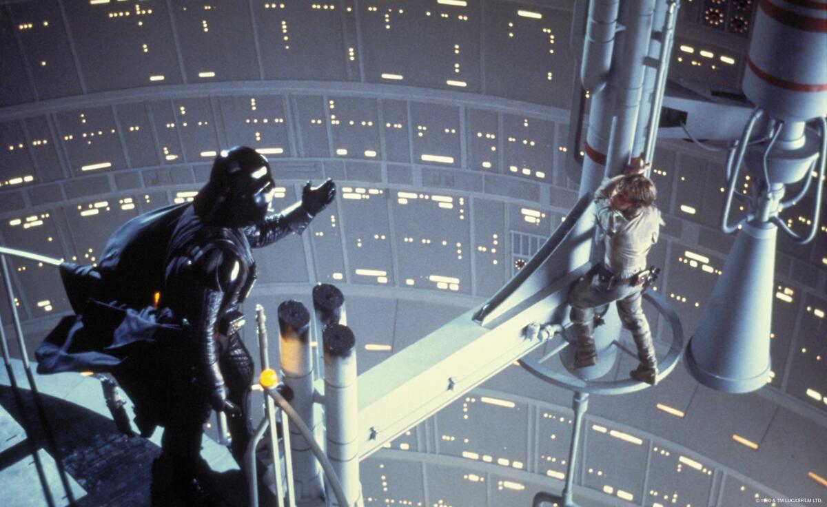Darth Vader reaches out to Luke Skywalker, who is balanced in a precarious position on space scaffolding