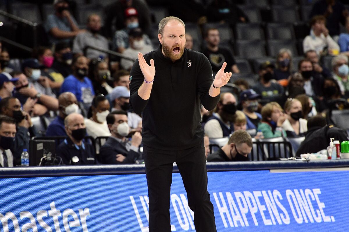Memphis Grizzlies head coach Taylor Jenkins calls to players from the sideline in the first half of an NBA preseason basketball game against the Detroit Pistons, Monday, Oct. 11, 2021, in Memphis, Tenn. (AP Photo/Brandon Dill)