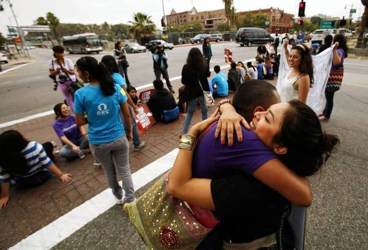 Nancy Guarneros, 25, right, hugs Jorge Gutierrez, 28, as they join more than 150 students and Dream Act supporters who rallied in downtown Los Angeles to voice support for President Obama's decision to halt the deportation of young illegal immigrants who have no criminal records and meet certain other criteria.
