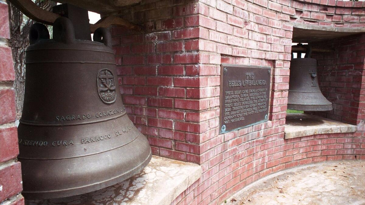 File photos of two bells of Balangiga at F.E. Warren Air Force Base outside Cheyenne, Wyo.,
