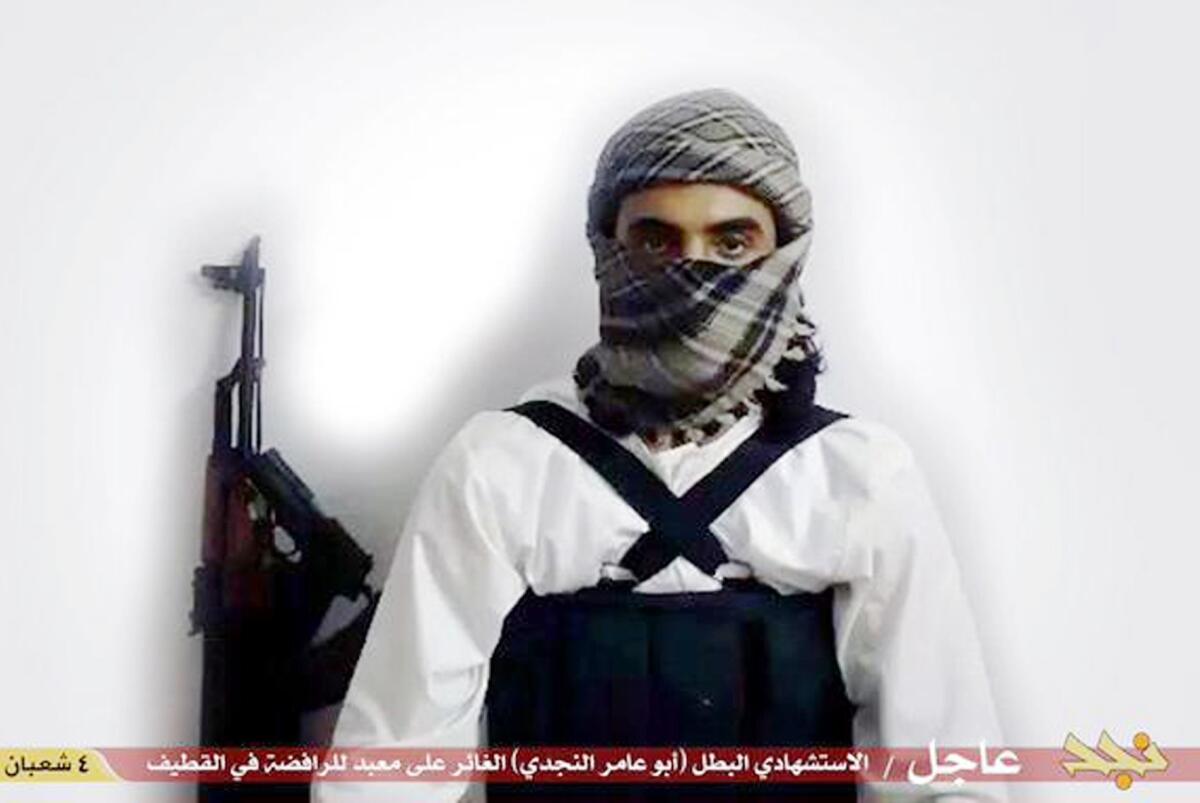 This image taken from a militant website associated with Islamic State extremists, posted May 23, 2015, purports to show a suicide bomber, with the Arabic bar below reading: "Urgent: The heroic martyr Abu Amer al-Najdi, the attacker of the (Shiite) temple in Qatif", which the Islamic State group's radio station claimed responsibility for.