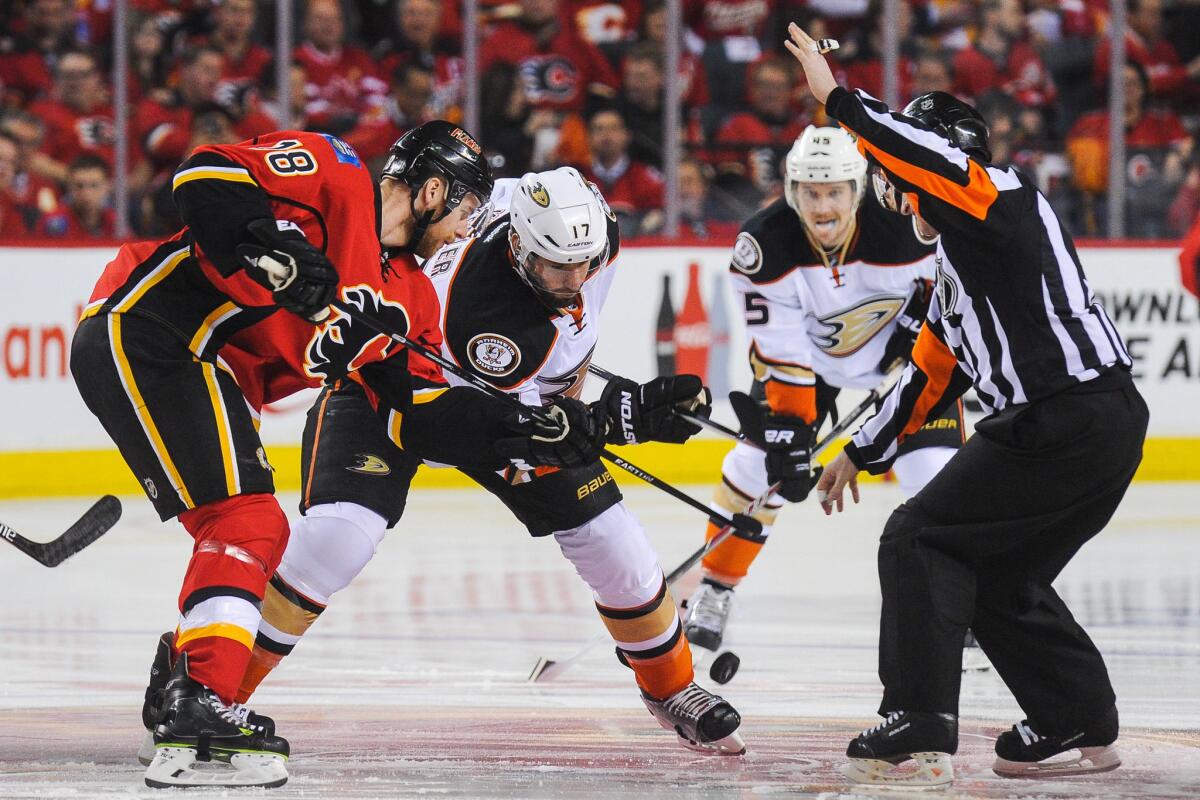 Calgary's Matt Stajan and Ryan Kesler face off Tuesday during Game 3 of the Western Conference semifinals series between with Flames and the Ducks.