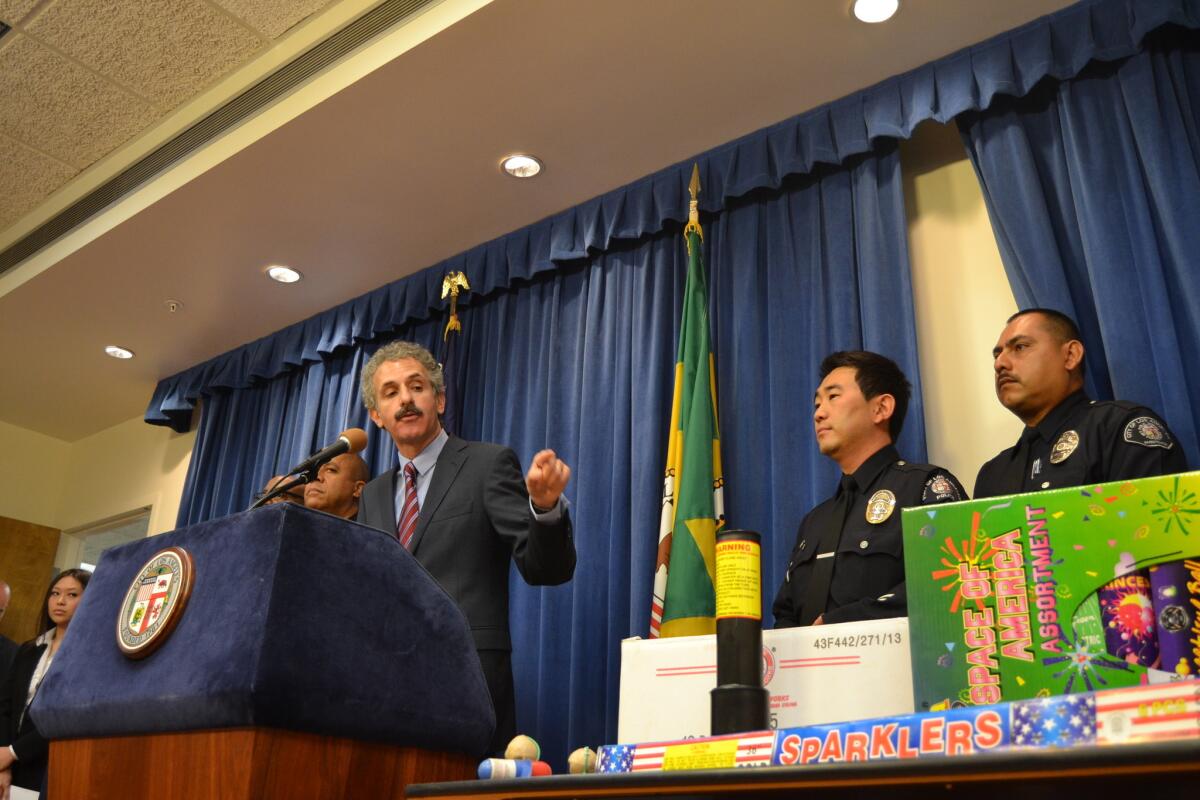 Los Angeles City Atty. Mike Feuer displays illegal fireworks seized as part of an ongoing city campaign.