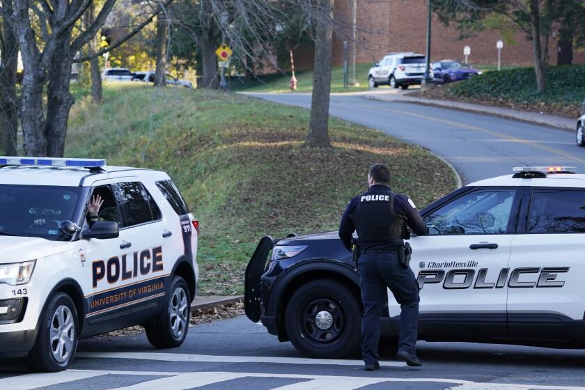 Charlottesville police secure a crime scene of an overnight shooting at the University of Virginia, Monday, Nov. 14, 2022, in Charlottesville. Va. (AP Photo/Steve Helber)