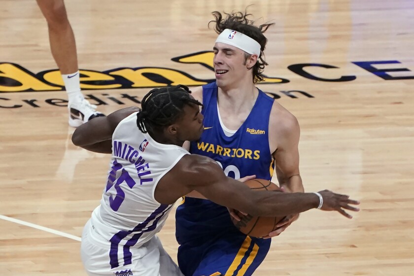 Sacramento Kings rookie guard Davion Mitchell, left, fouls Golden State Warriors forward Nick Mayo during the second half of a California Classic NBA summer league basketball game in Sacramento, Calif., Tuesday, Aug. 3, 2021. (AP Photo/Rich Pedroncelli)