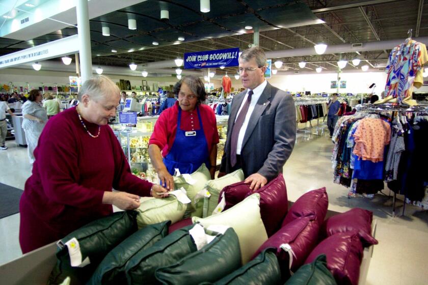 ADVANCE FOR USE ANYTIME––Michael Miller, president and CEO of the Portland–area Goodwill Industries, right, looks on as employees Cathy Barrett, left, and Norma Millner check pillow prices at a Goodwill Industries store in Portland, Ore., Monday, June 5, 2000. The same Goodwill that used to be associated with dingy stores, musty clothing and knick knacks haphazardly arranged now has advertisements that look like they could be for the Gap or Target. The ads are part of an innovative marketingstrategy used by Goodwill Industries in the Portland Area, _ the most successful Goodwill retail chain in North America. (AP Photo/Don Ryan)