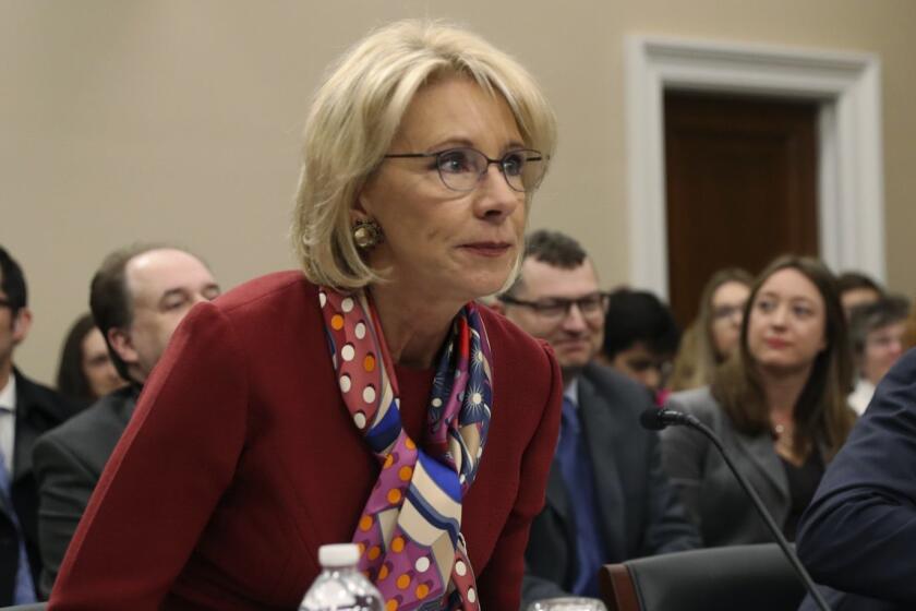Education Secretary Betsy DeVos, left, takes her seat before a House Committee on Appropriation subcommittee hearing on Capitol Hill in Washington, Tuesday, March 20, 2018. With DeVos is Bill Cordes, right, Dept. of Education Budget Service Elementary, Secondary and Vocational Analysis Division Director. (AP Photo/Pablo Martinez Monsivais)