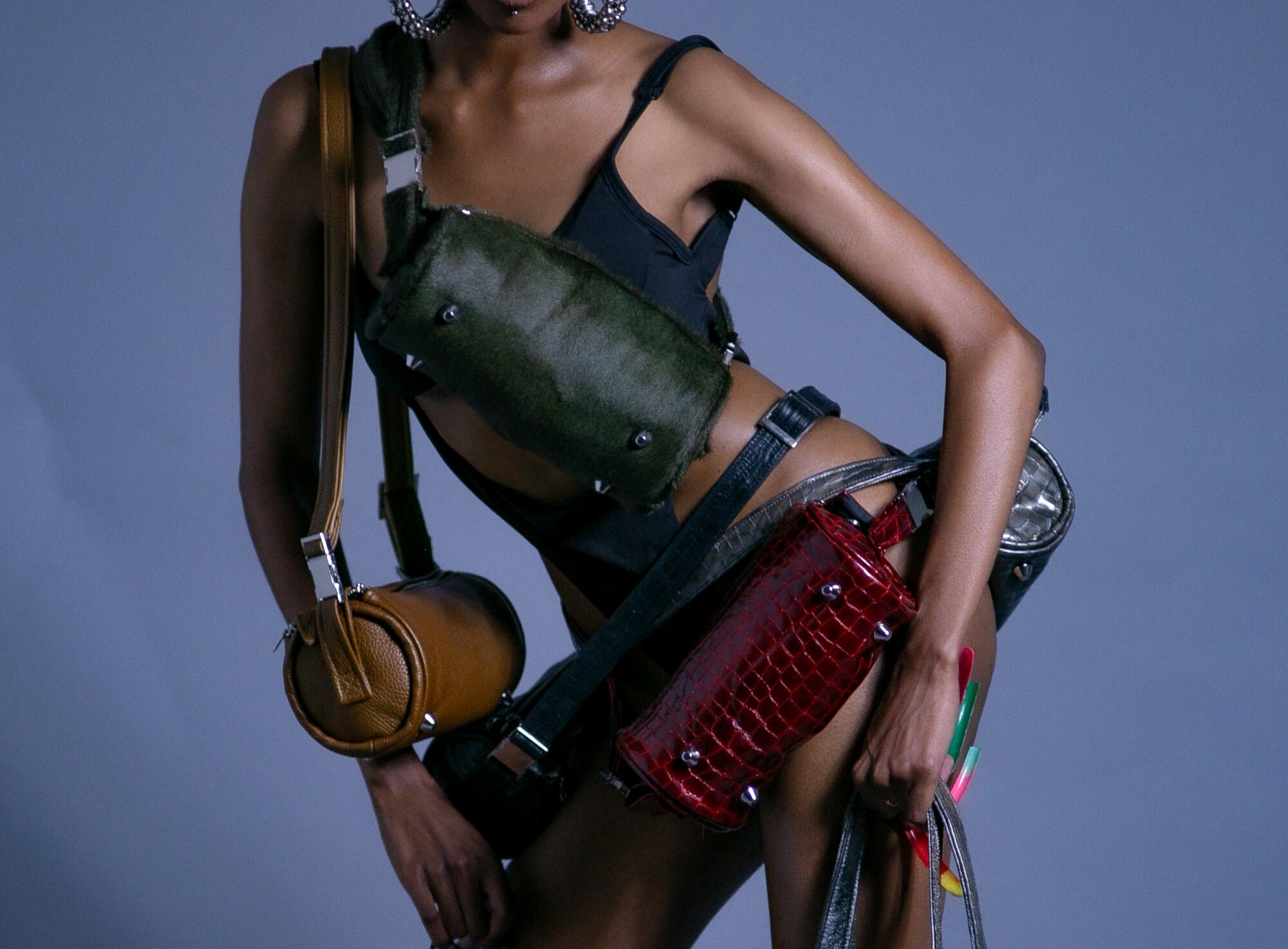 A model's torso and arms wrapped in black Carry bags
