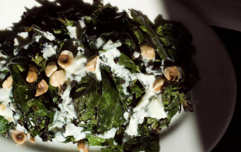 Grilled Russian kale with yogurt dressing and toasted hazelnuts