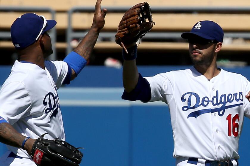 Dodgers outfielders Carl Crawford, left, and Andre Ethier celebrate after a 2013 win. Crawford has had more starts in left field than Ethier has had in recent games.