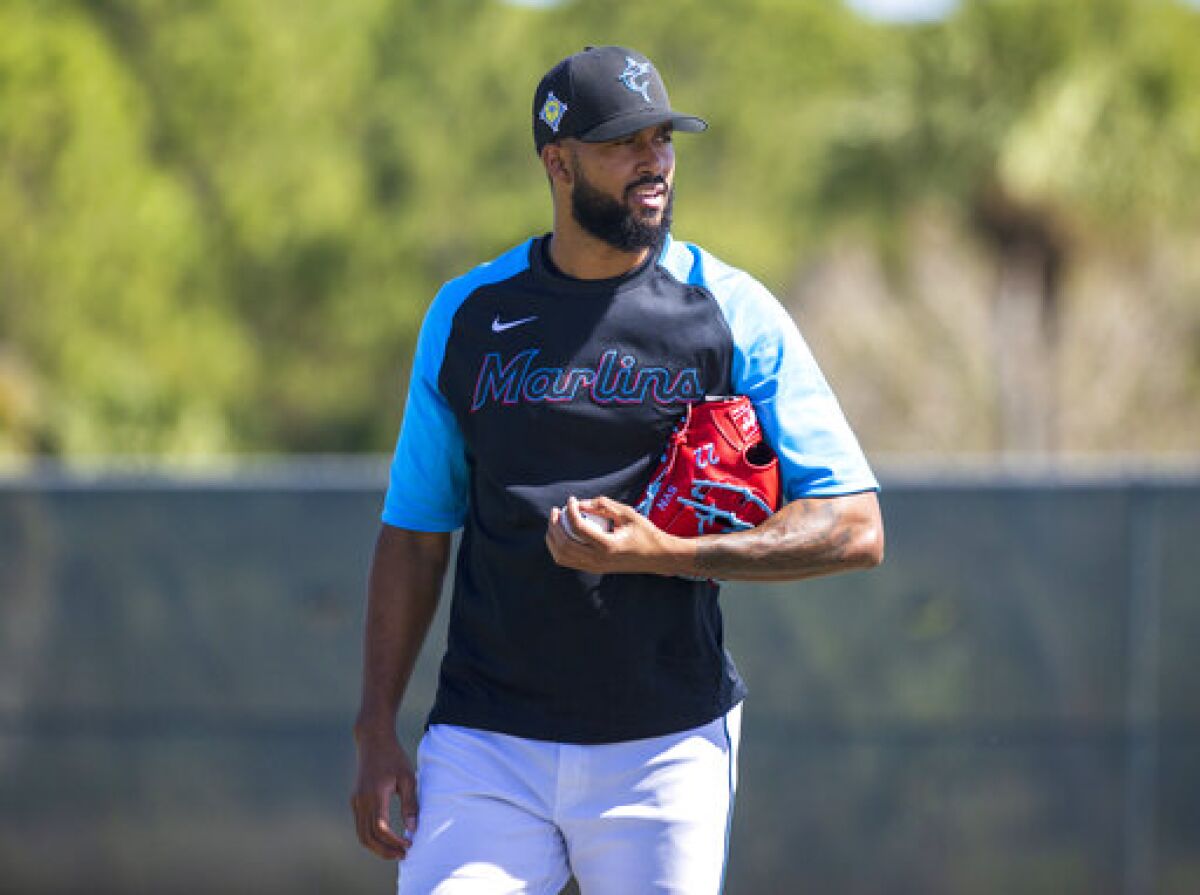 Miami Marlins pitcher Sandy Alcantara (22) looks on during the team's first full-squad spring training baseball workout Monday, March 14, 2022, in Jupiter, Fla. (David Santiago/Miami Herald via AP)