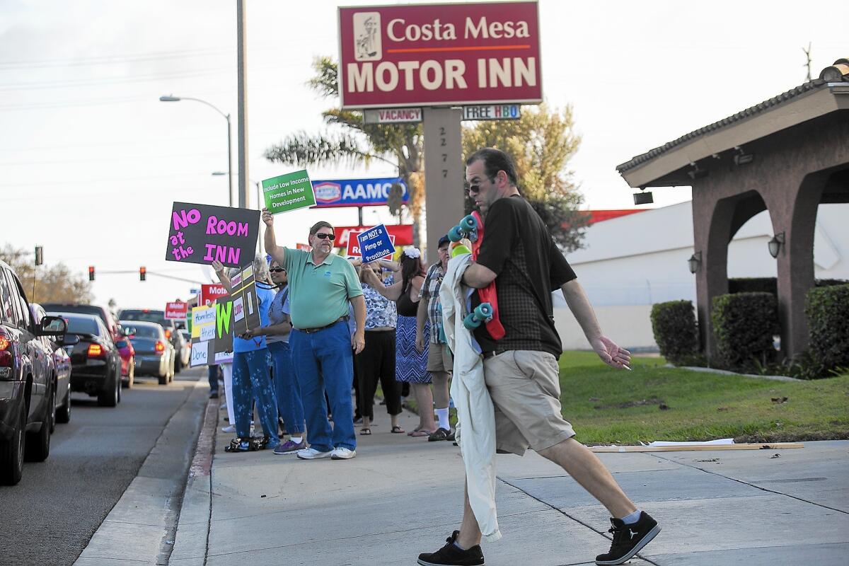 Affordable-housing advocates had urged Costa Mesa officials to incorporate new low-cost units into a proposed incentive program. The Costa Mesa Motor Inn, pictured in October during a protest by affordable-housing advocates, was one of the properties targeted under the program. Council members declined to move ahead with such a program during their meeting Tuesday night.