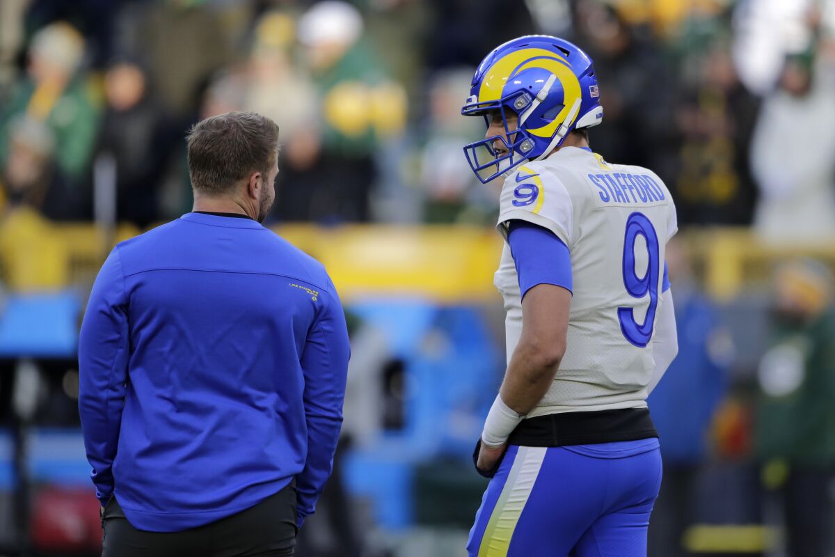 Rams quarterback Matthew Stafford talks with coach Sean McVay before a game against the Green Bay Packers.
