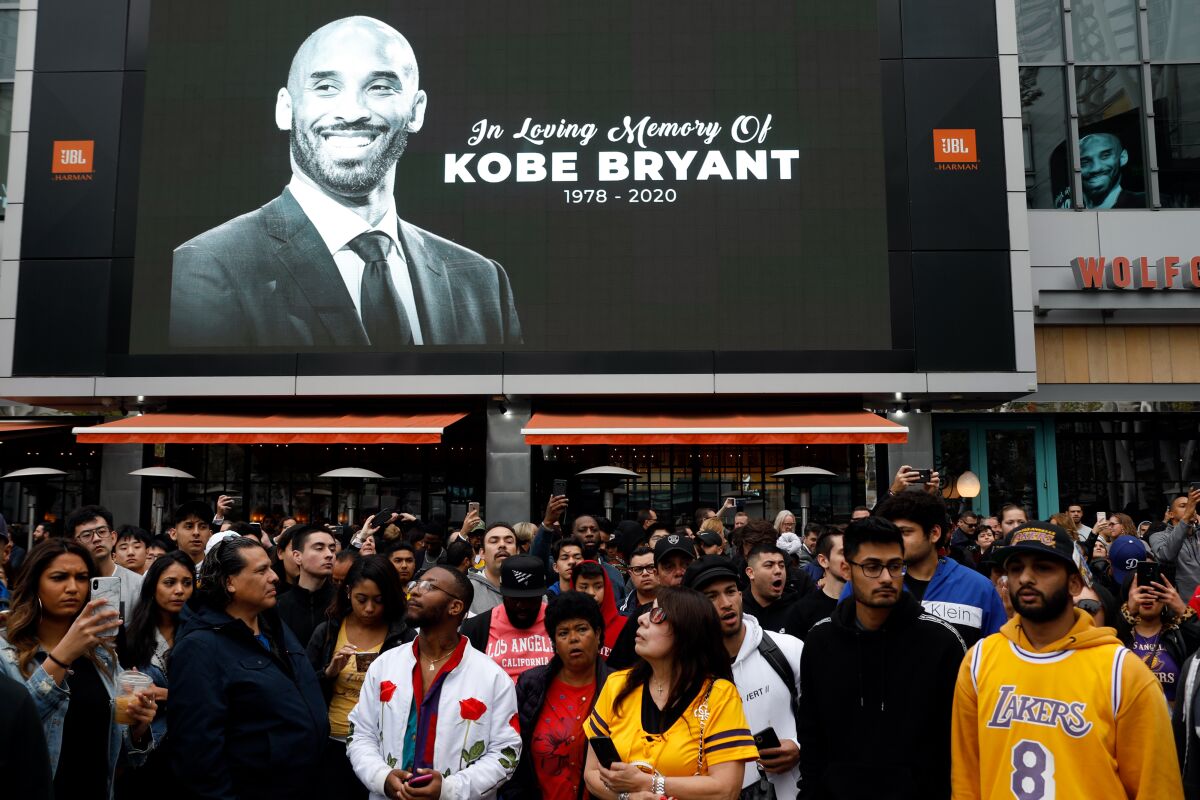 Fans gather near a memorial for Kobe Bryant.