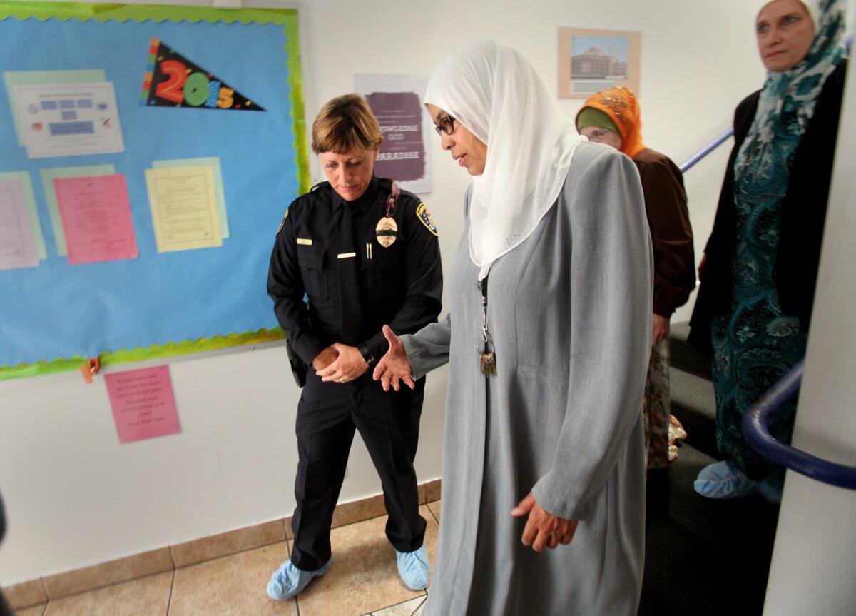 San Diego Police officer Heather Leavall walks and talks about proper contact between men and women, with Dr. Sharifa Abukar, principal of the Islamic School at the Islamic Center of San Diego. San Diego Police Department's newest police officers who had barely graduated from the academy Friday visited various community centers, starting with the Islamic Center, to learn about cultural and religious issues that might seem strange or confusing to the officers, especially in an emergency situation. — Peggy Peattie