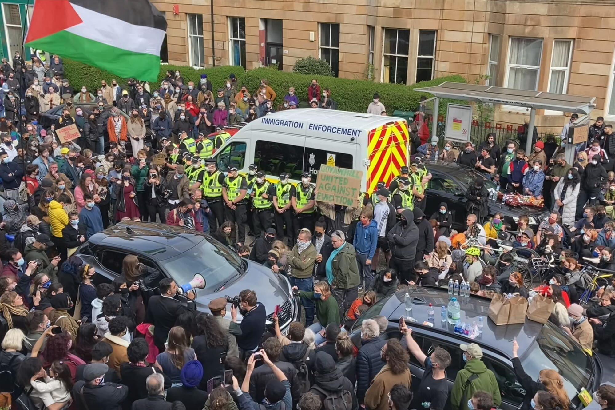 Protesters swarm a paddy wagon.
