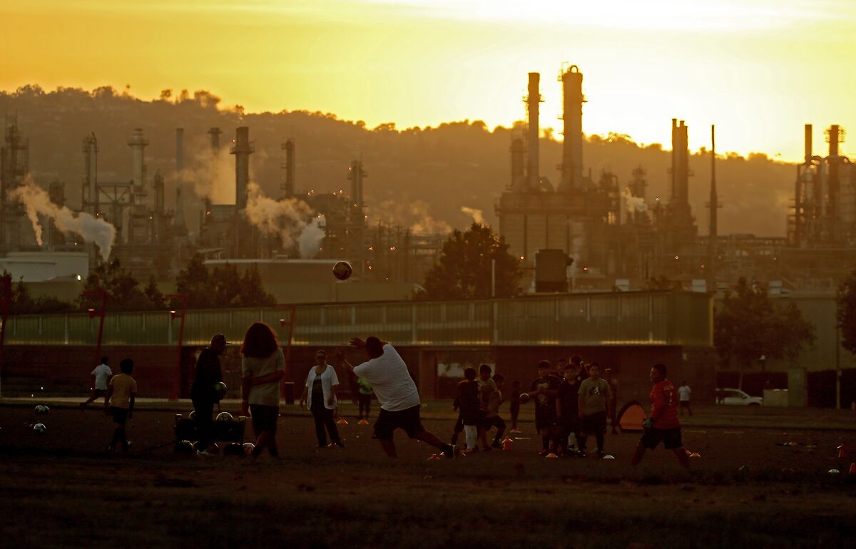 Youth soccer teams practice at Wilmington Waterfront Park in the shadow of the Conoco Phillips refinery. 