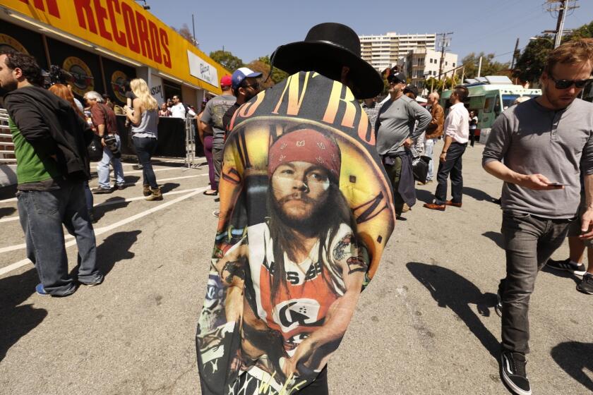 Lauren Graham, 35, wears an Axl Rose flag as she gathers with Guns N' Roses fans who waited hours to buy tickets for the band's surprise show Friday at the Troubadour.
