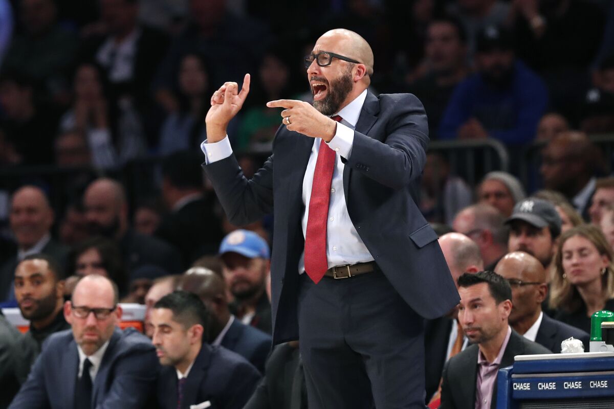 New York Knicks coach David Fizdale yells and gestures with his fingers as he instructs his players during a game