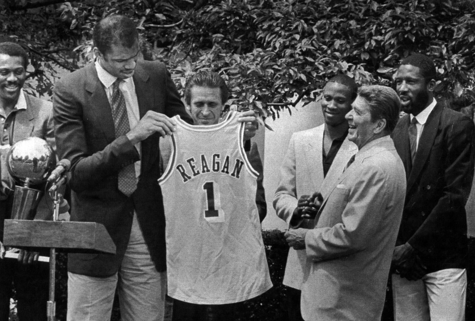 Kareem Abdul-Jabbar presents a Lakers jersey to President Reagan