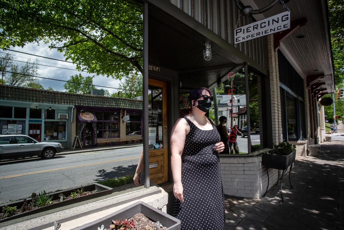 Christina Blossey, owner of a body piercing business, Piercing Experience, says her business is likely to remain closed until she can be assured that she can acquire masks and cleaning materials regularly to keep her customers safe.