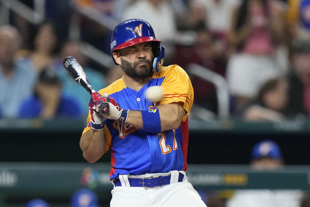 Venezuela's José Altuve is hit by a pitch during the fifth inning March 18, 2023, in Miami. 