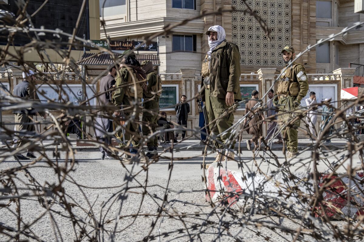 Taliban fighters stand guard at the explosion site, near the Foreign Ministry in Kabul, Afghanistan, Monday, March 27, 2023. A suicide bomber has struck near the foreign ministry in the Afghan capital, killing at least six people and wounding about a dozen. (AP Photo/Ebrahim Noroozi)