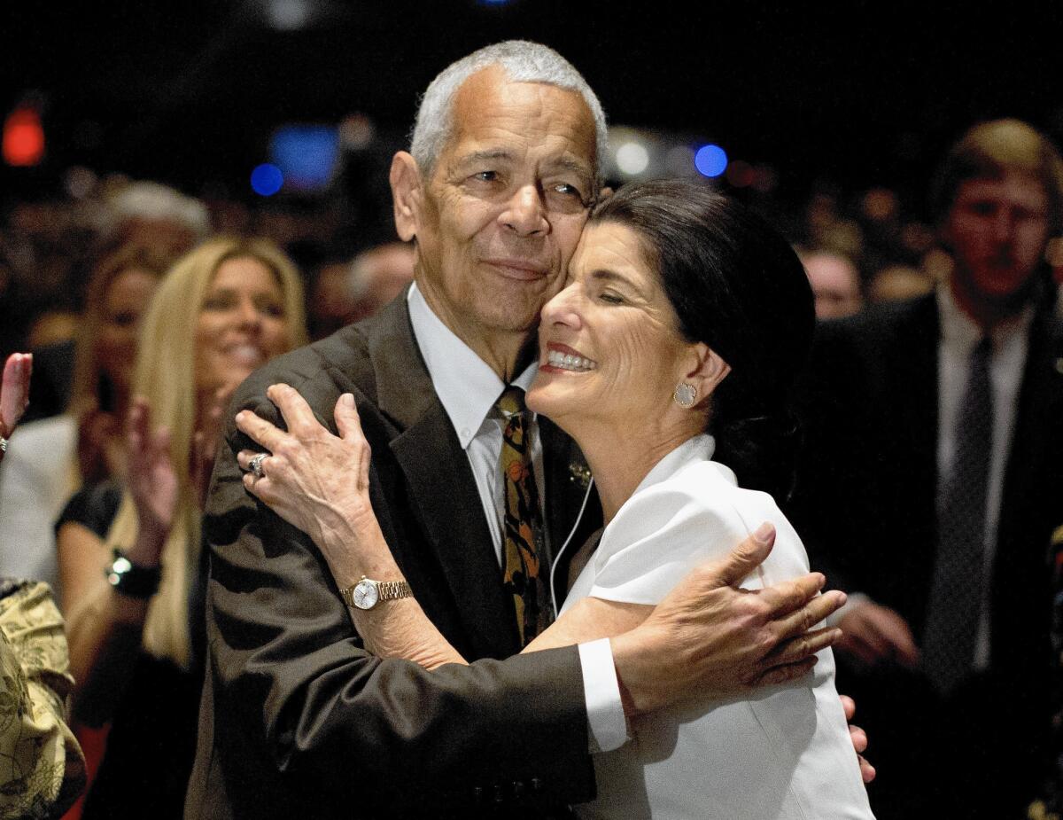 Social activist Julian Bond hugs Luci Baines Johnson, daughter of President Lyndon B. Johnson, during the Civil Rights Summit in April 2014. Bond has died at 75.