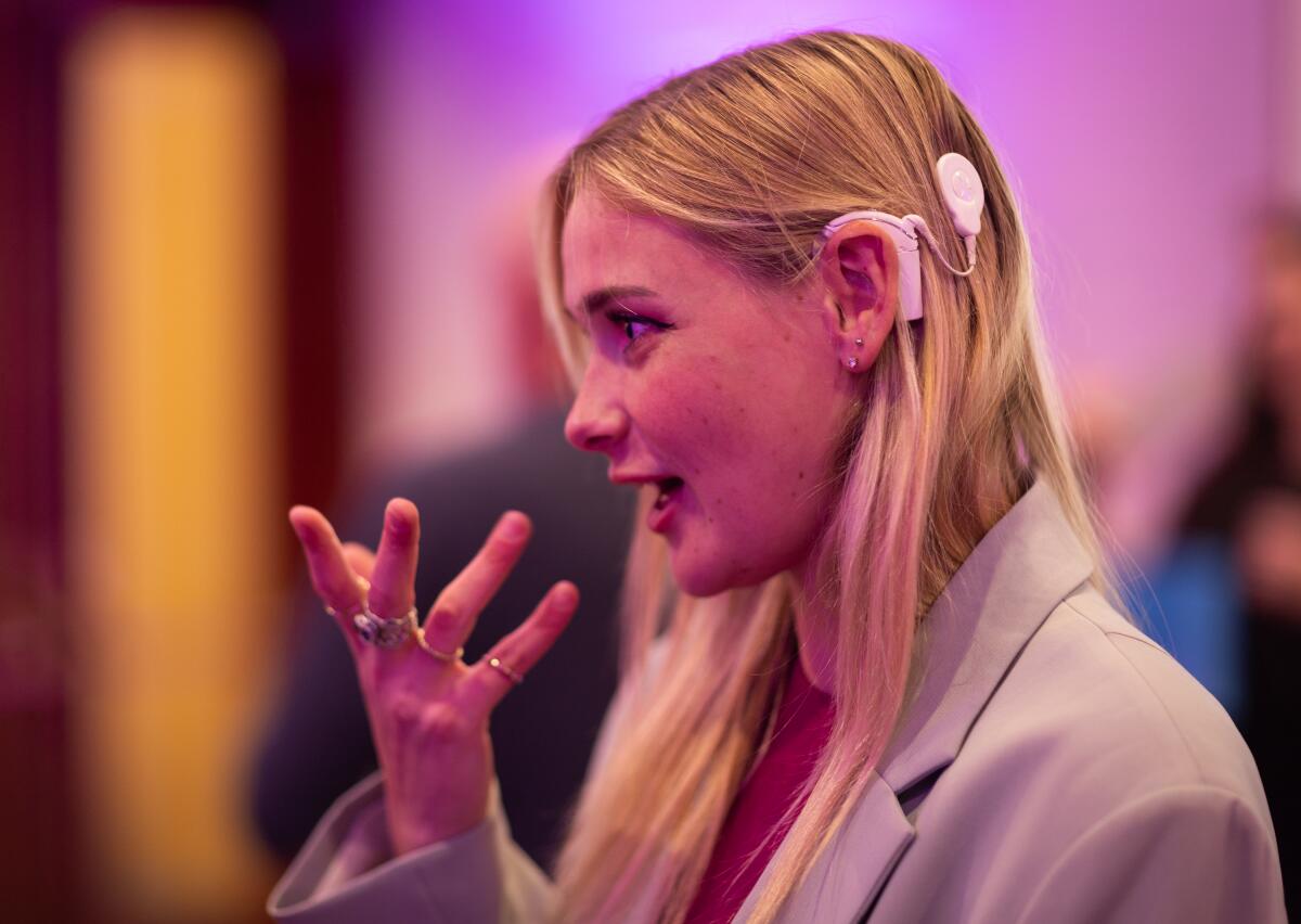 Chrissy Marshall, a writer and director from Los Angeles, wears a cochlear implant while signing.