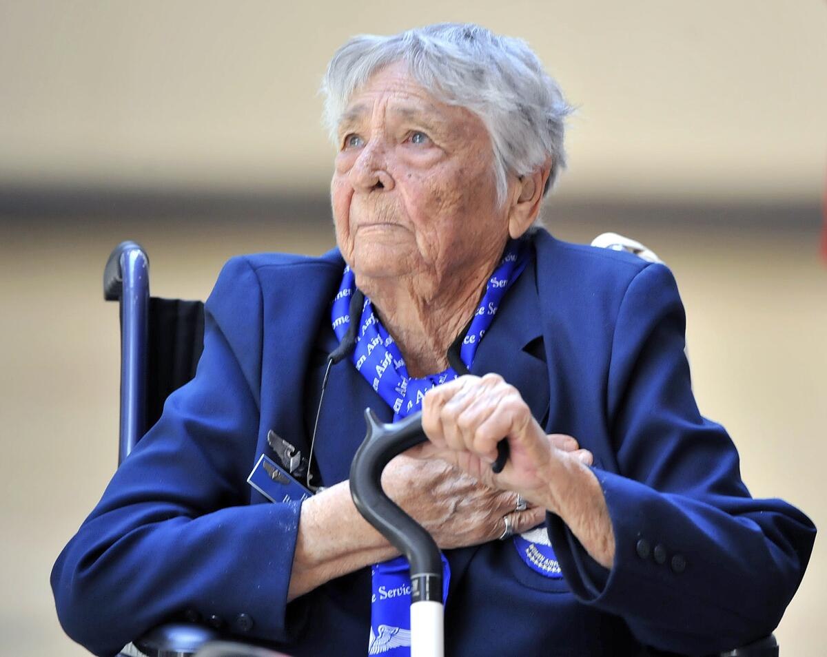Honoree Beverly Beesemyer puts her hand on her heart during the Pledge of Alegiance at an assembly honoring the 1937 Flintridge Sacred Heart Academy graduate at FSHA on Wednesday, March 12, 2014. Beesemyer was a WASP in WWII, one of a group of women who were the first female aviators in the military. She was honored with the Congressional Medal of Honor in 2010.