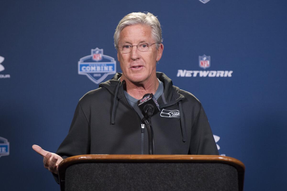 Seattle Seahawks Coach Pete Carroll talks with reporters Friday at the NFL scouting combine in Indianapolis.