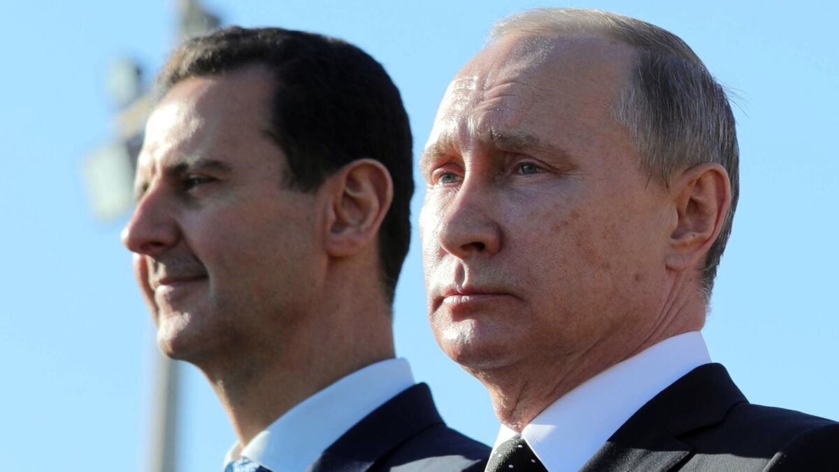 Russian President Vladimir Putin, right, and Syrian President Bashar Assad, left, at the Hemeimeem air base in Syria on Dec. 11, 2017.