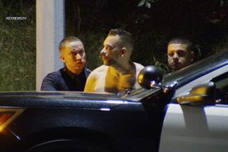 LAPD officers take a man into custody early Wednesday morning after allegedly attempting to break into a Studio City home.