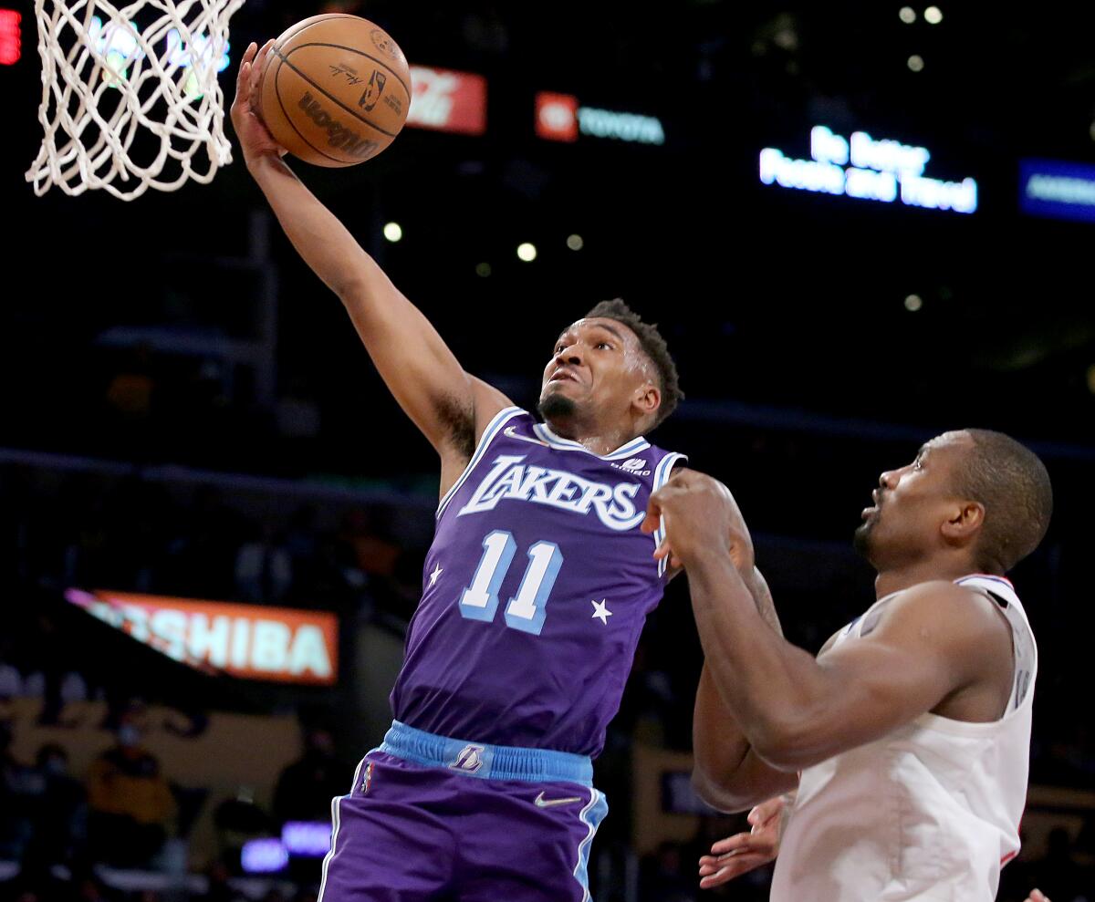 Lakers guard Malik Monk scores a basket against Clippers center Serge Ibaka.