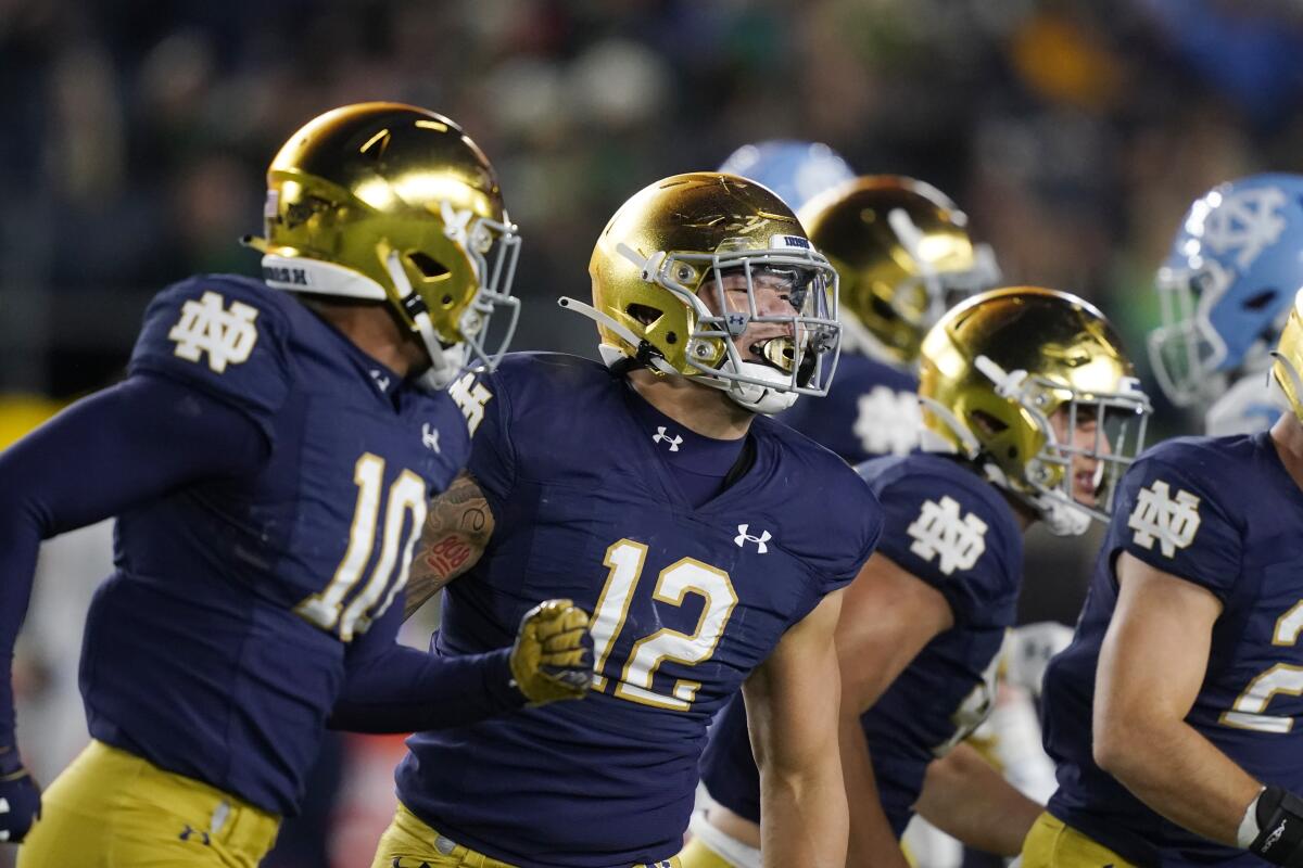 Notre Dame linebacker Isaiah Pryor and defensive lineman Jordan Botelho celebrate after a play against North Carolina.