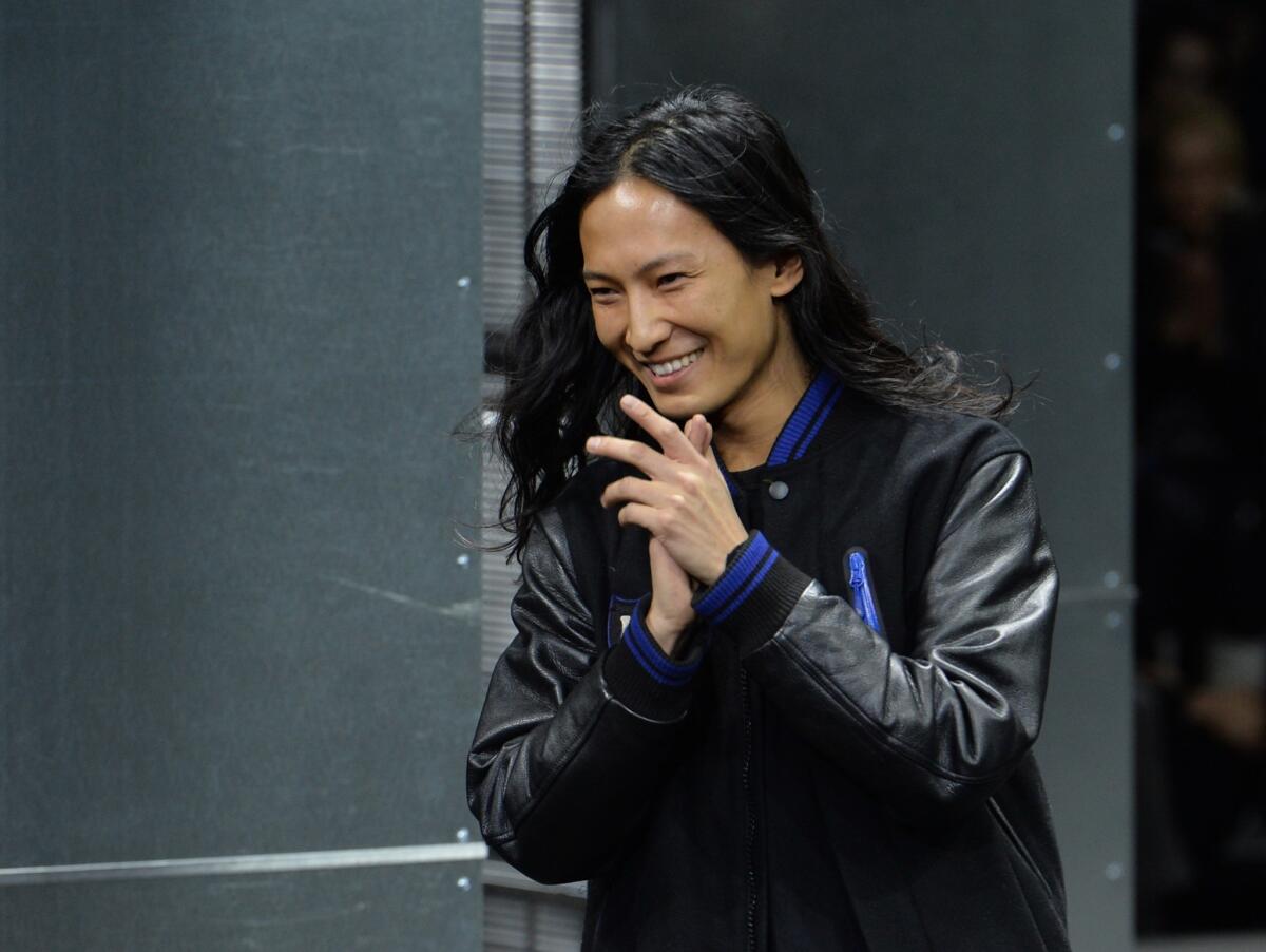 Alexander Wang applauds on the runway during the Mercedes Benz Fall/Winter 2014 Fashion Shows in New York.