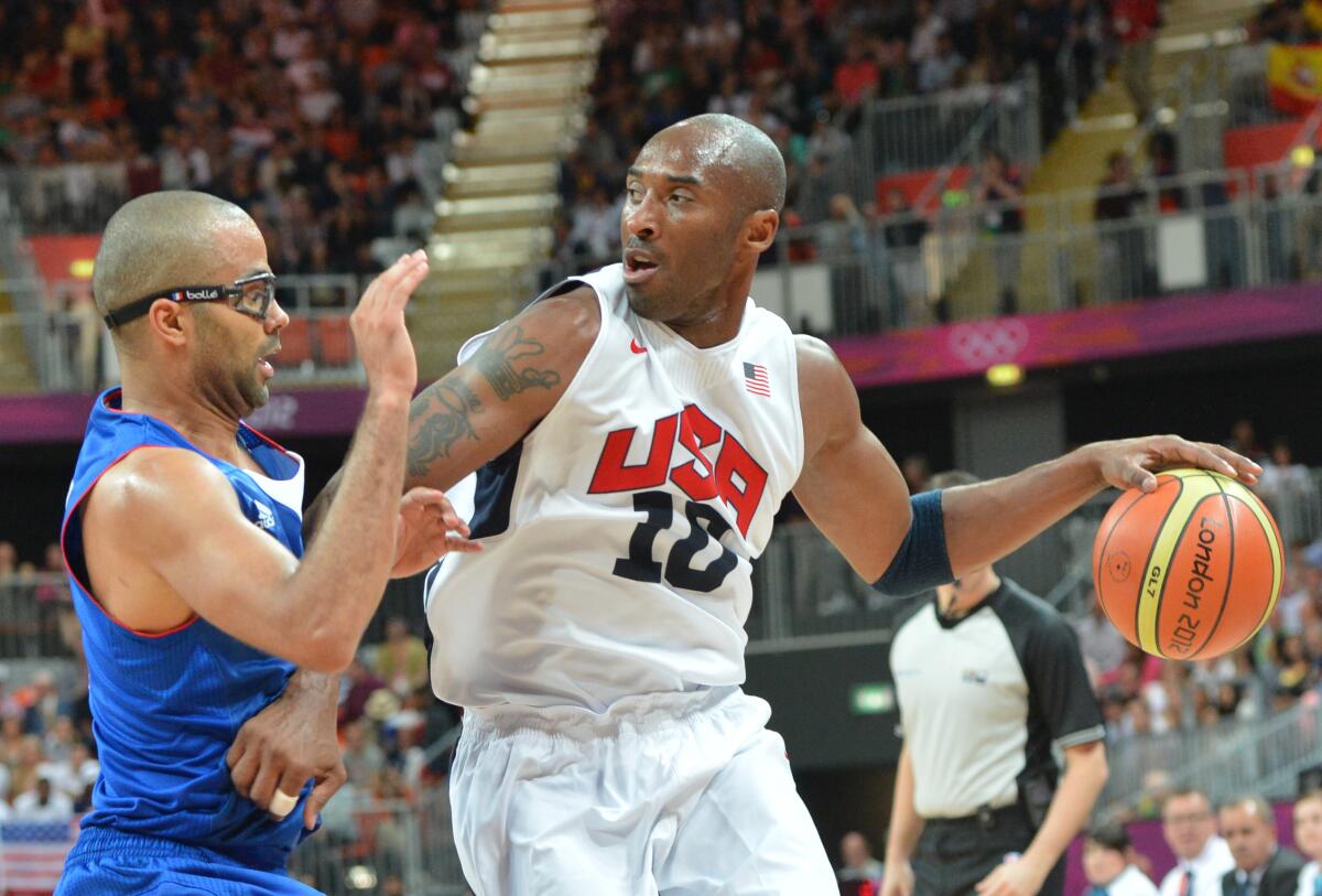 U.S. guard Kobe Bryant is challenged by French guard Tony Parker during a preliminary round game at the 2012 London Olympics.