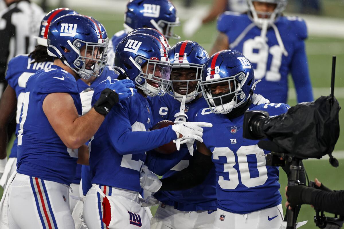 New York Giants safety Xavier McKinney celebrates with teammates.