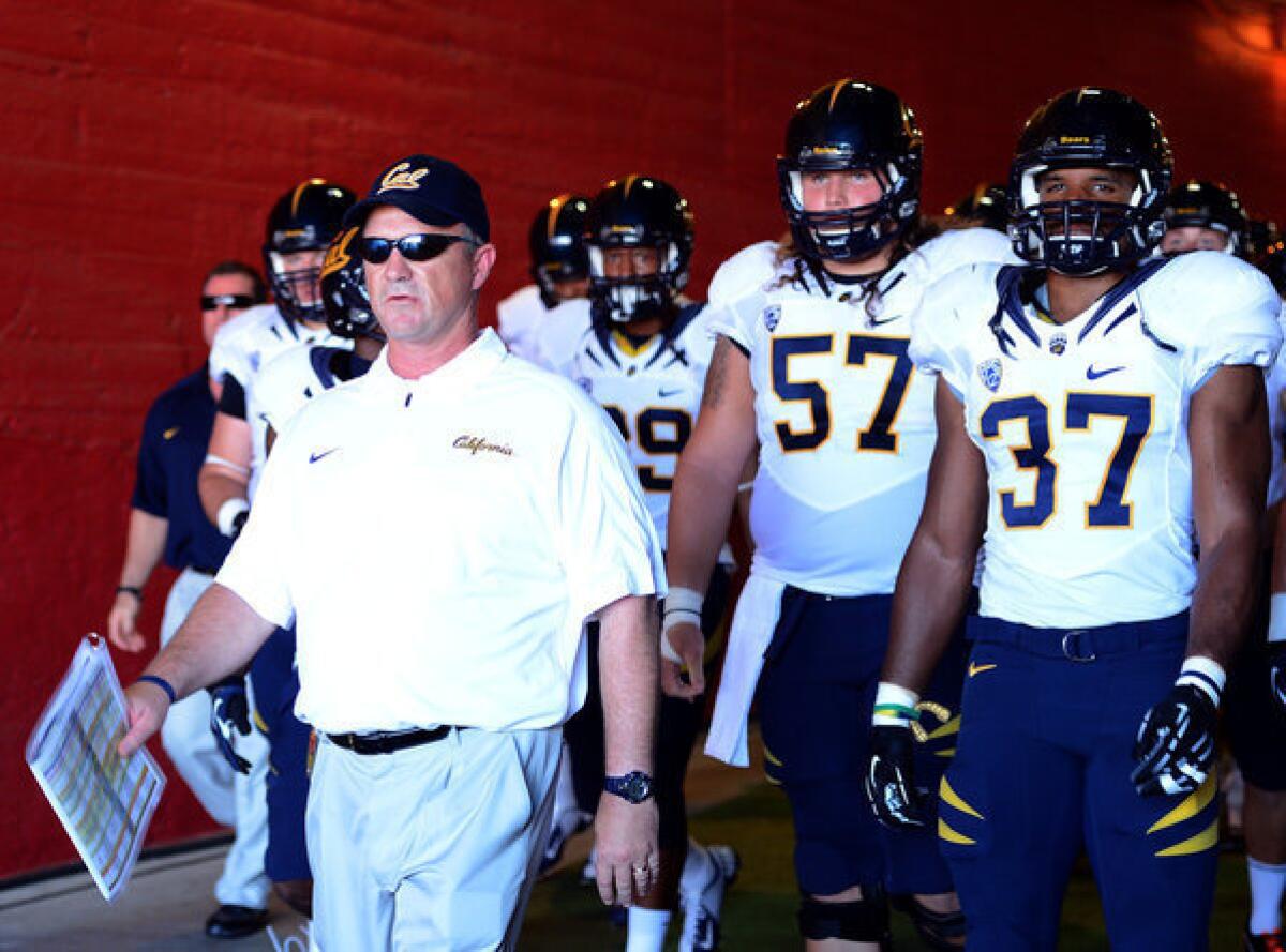 Coach Jeff Tedford of the California Golden Bears leads his team onto the field.
