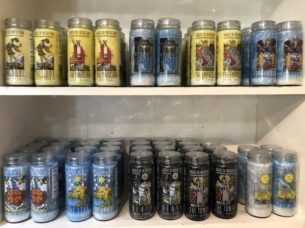 Tarot candles in different colors on two shelves